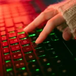 Person typing on illuminated keyboard representing blog writing services by a freelance digital marketer in Kochi