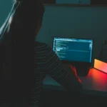 Freelance digital marketer in Kochi working on content writing and website optimization on a laptop