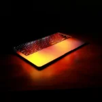 freelance digital marketer in kochi-a laptop opened slightly with warm lighting from laptop in a table